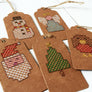 Five designs of stitched tags shown together on an angle