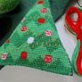 Christmas tree shaped cross stitch decoration with threads
