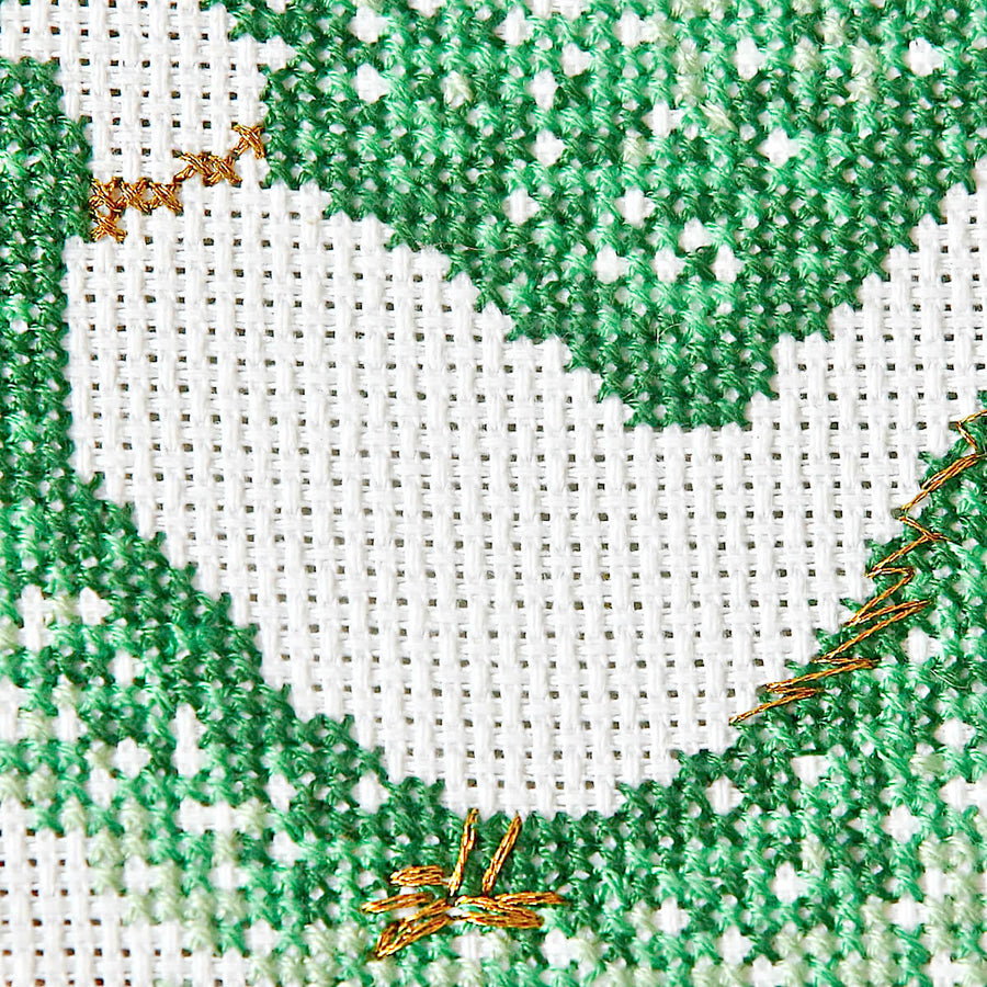 Close up of graduate colour green stitches around pheasant outline and gold collar and feet details