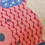 Pink teddy cross stitch pattern close up of stitches.