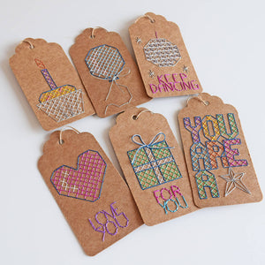 Six cross stitch gift tags patterns including keep dancing, balloon, gift heart and you are a star designs.