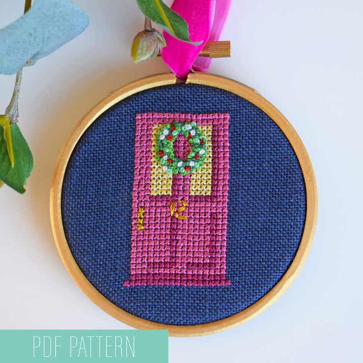Stitched 3 inch hoop bauble pattern featuring pink front door with Christmas wreath stitched in French knots