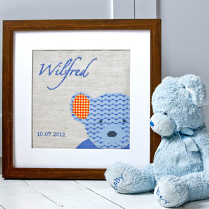 Blue teddy cross stitch design framed, with blue teddy