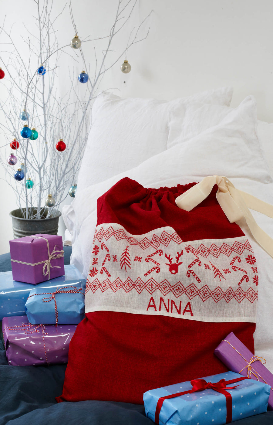 Image from the inside of the book of a personalised cross stitch Christmas sack