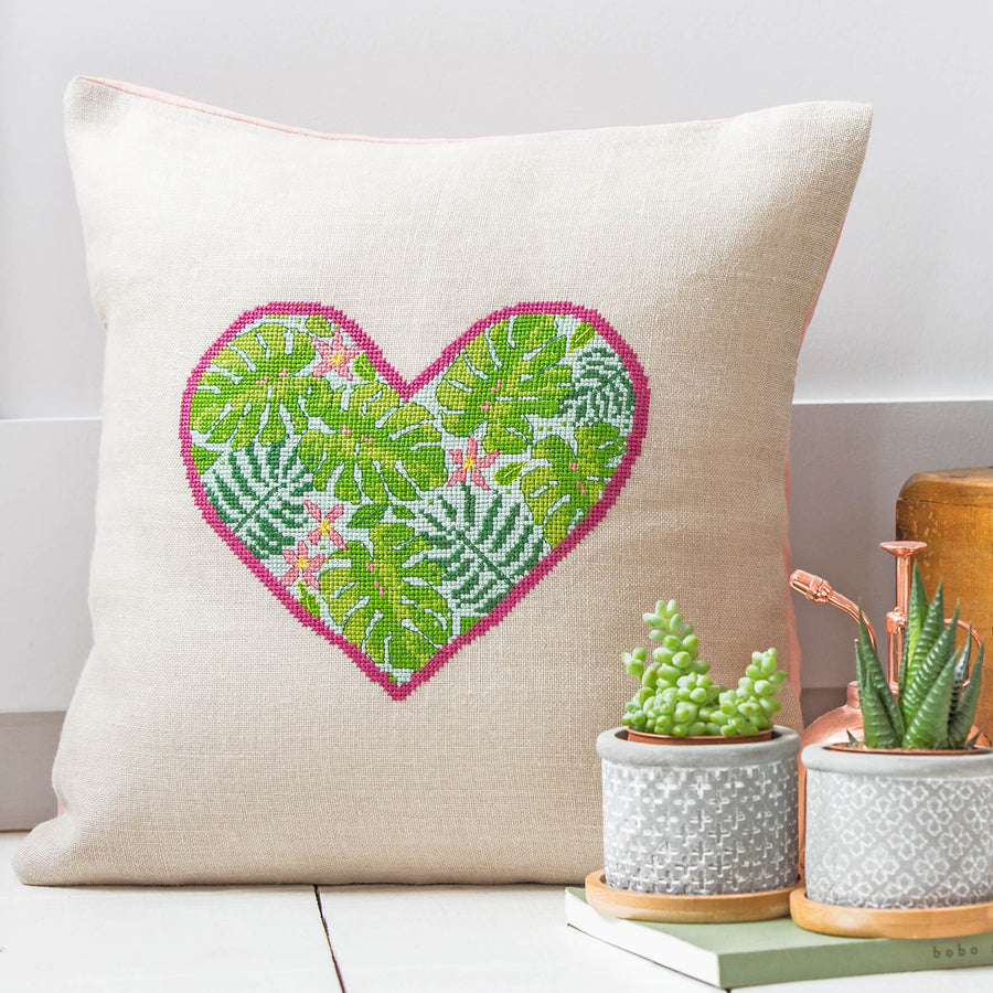 Cross stitch kit featuring leaves in a heart shape made into a cushion.