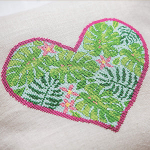 Cross stitch heart design full of green leaves and pink flowers