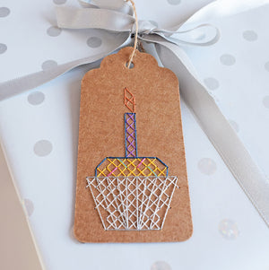 Cross stitch gift tag of birthday cupcake on gift