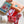 Contents of cross stitch Christmas jumper kit including letterbox packaging, stuffing, white aida, ribbon, threads, ribbon and red felt