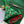 Cross stitch Christmas tree lying on kit materials including green felt, white aida, ribbon and threads