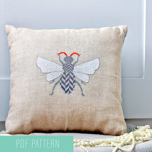 Bee featuring herringbone pattern cross stitched onto a cushion