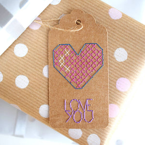 Love you heart birthday gift tag cross stitched on gift.