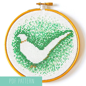 Negative space cross stitch pattern of green pheasant outline show in five inch hoop