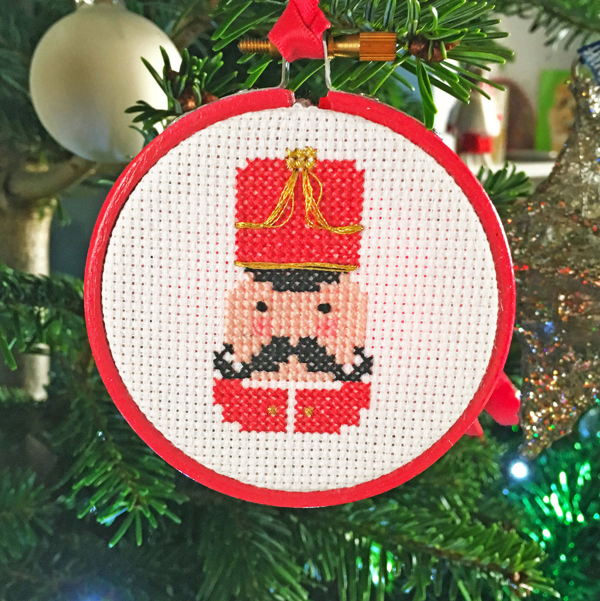 3 inch hoop cross stitch Christmas bauble featuring nut cracker soldier head and shoulders design