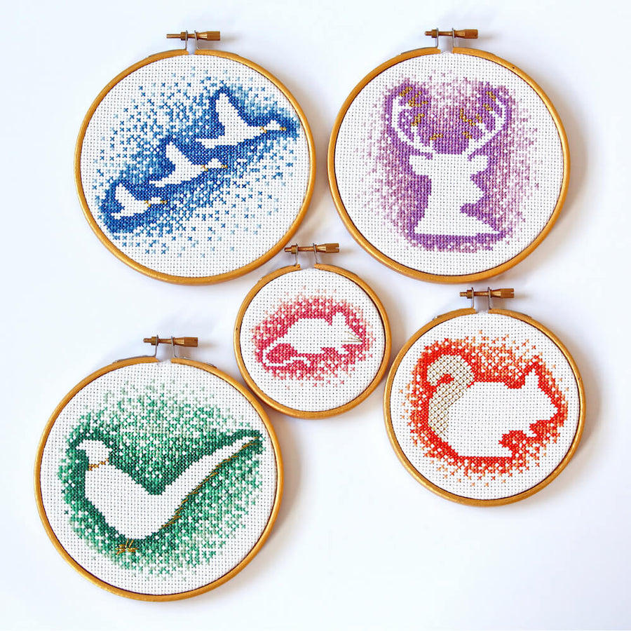 5 negative space cross stitch patterns including blue ducks, orange squirrel, purple stag, green pheasant and pink mouse